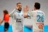 Marseille's Florian Thauvin, right, celebrates his goal with his teammate Dario Benedetto against Rennes during the French League One soccer match between Marseille and Reims at the Stade Velodrome in Marseille, southern France, Saturday Dec. 19, 2020. (AP Photo/Daniel Cole)