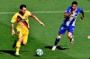 Barcelona's Lionel Messi, left, fights for the ball with Alaves' Victor Camarasa during the Spanish La Liga soccer match between Alaves and FC Barcelona, at Mendizorroza stadium, in Vitoria, northern Spain, Sunday, July 19, 2020. (AP Photo/Alvaro Barrientos)
