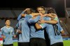 Players of Uruguay celebrate after Luis Suarez scored from the penalty point the opening goal against Chile during a qualifying soccer match for the FIFA World Cup Qatar 2022 at the Centenario stadium in Montevideo, Uruguay, Thursday, Oct. 8, 2020. (Raul Martinez/Pool via AP)