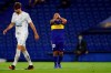 Carlos Tevez of Argentina's Boca Juniors covers his face during a Copa Libertadores semifinal first leg soccer match against Brazil's Santos at the Bombonera stadium in Buenos Aires, Argentina, Wednesday, Jan. 6, 2021. (Agustin Marcarian/Pool via AP)