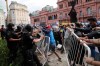 Soccer fans waiting to see Diego Maradona lying in state clash with police outside the presidential in Buenos Aires, Argentina, Thursday, Nov. 26, 2020. The Argentine soccer great who led his country to the 1986 World Cup title died Wednesday at the age of 60. (AP Photo/Rodrigo Abd)