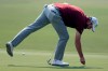 Australia's Marc Leishman fixes a pitch mark on the 2nd green during the opening round of the Australian Open golf tournament in Sydney, Thursday, Dec. 5, 2019. (AP Photo/Rick Rycroft)