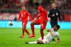 Bayern's Alphonso Davies, centre, and Leipzig's Tyler Adams challenge for the ball during the German Bundesliga soccer match between Bayern Munich and RB Leipzig at the Allianz Arena in Munich, Germany, Sunday, Feb. 9, 2020. (AP Photo/Matthias Schrader)