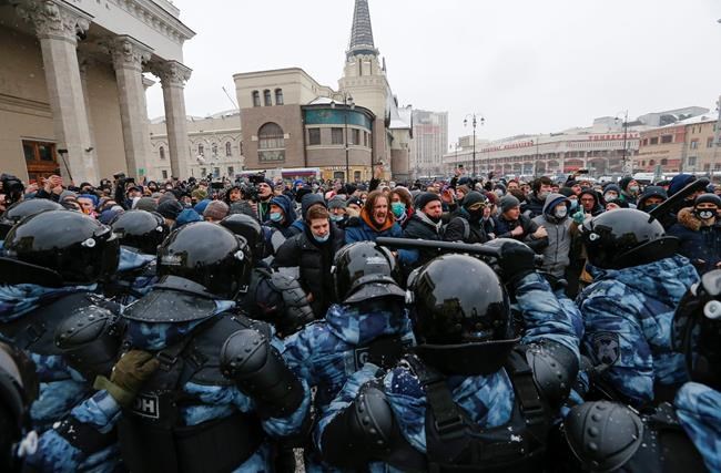 People clash with police during a protest against the jailing of opposition leader Alexei Navalny in Moscow, Russia, Sunday, Jan. 31, 2021. Thousands of people took to the streets Sunday across Russia to demand the release of jailed opposition leader Alexei Navalny, keeping up the wave of nationwide protests that have rattled the Kremlin. Hundreds were detained by police. (AP Photo/Alexander Zemlianichenko)