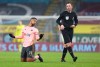 Sheffield United's Lys Mousset reacts as referee Chris Kavanagh passes by during the English Premier League soccer match between Burnley and Sheffield United at the Turf Moor stadium in Burnley, England, Tuesday, Dec. 29, 2020. (Barrington Coombs/Pool via AP)