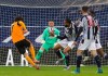 Wolverhampton Wanderers' Fabio Silva, left, scores his side's opening goal during an English Premier League soccer match between West Bromwich Albion and Wolverhampton Wanderers at The Hawthorns in West Bromwich, England, Monday, May 3, 2021. (Geoff Caddick /Pool via AP)