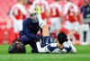 Tottenham's Son Heung-min receives medical attention during the English Premier League soccer match between Arsenal and Tottenham Hotspur at the Emirates stadium in London, England, Sunday, March 14, 2021. (Julian Finney/Pool via AP)