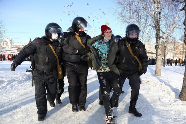 Police detain a man during a protest against the jailing of opposition leader Alexei Navalny in Siberian city of Omsk, Russia, on Sunday, Jan. 31, 2021. Thousands of people took to the streets Sunday across Russia to demand the release of jailed opposition leader Alexei Navalny, keeping up the wave of nationwide protests that have rattled the Kremlin. Hundreds were detained by police. (AP Photo)