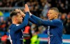 PSG's Kylian Mbappe, right, celebrates with teammate Juan Bernat after scoring his side's fourth goal during the French League One soccer match between Paris-Saint-Germain and Dijon, at the Parc des Princes stadium in Paris, France, Saturday, Feb. 29, 2020. (AP Photo/Michel Euler)