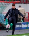 Atletico Madrid's head coach Diego Simone kicks the ball during the Champions League Group A soccer match between Lokomotiv Moscow and Atletico Madrid in Moscow, Russia, Tuesday, Nov. 3, 2020. (Maxim Shemetov/Pool via AP)
