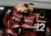 Leeds United's Patrick Bamford, left, celebrates after scoring his side's opening goal during the English Premier League soccer match between Fulham and Leeds United, at Craven Cottage stadium, London, Friday, March 19, 2021. (AP Photo/Matt Dunham, Pool)