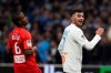 Marseille's Nemanja Radonjic celebrates ahead of Brest's Ibrahima Diallo after scoring his side's second goal during the French League One soccer match between Marseille and Brest at the Velodrome stadium in Marseille, southern France, Friday, Nov. 29, 2019. (AP Photo/Daniel Cole)