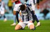 West Bromwich Albion's Okay Yokuslu sits on the pitch in dejection at the end of the English Premier League soccer match between Aston Villa and West Bromwich Albion at Villa Park Stadium in Birmingham, England, Sunday, April 25, 2021. (Shaun Botterill/Pool via AP)