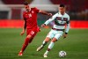 Serbia's Sergej Milinkovic-Savic, left, and Portugal's Cristiano Ronaldo challenge for the ball during the World Cup 2022 group A qualifying soccer match between Serbia and Portugal at the Rajko Mitic stadium in Belgrade, Serbia, Saturday, March 27, 2021. (AP Photo/Darko Vojinovic)