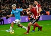 Manchester City's Sergio Aguero, left, and Sheffield United's Jack O'Connell challenge for the ball during the English Premier League soccer match between Sheffield United and Manchester City at Bramall Lane in Sheffield, England, Tuesday, Jan. 21, 2020. (AP Photo/Rui Vieira)