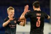 Manchester City's Oleksandr Zinchenko and Manchester City's Ruben Dias celebrate at the end of the English FA Cup sixth round soccer match between Everton and Manchester City at Goodison Park in Liverpool, England, Saturday, March 20, 2021. (AP Photo/Jon Super, Pool)