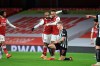 Arsenal's Pierre-Emerick Aubameyang, centre, celebrates with teammates after scoring his side's third goal during the English Premier League soccer match between Arsenal and Newcastle United at Emirates Stadium in London, England, Monday, Jan.18, 2021. (Adam Davy/Pool via AP)