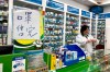 Pharmacist Liu Zhuzhen stands near a sign reading 