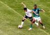 Corinthians' Ederson, left, fights for the ball with Palmeiras' Patrick de Paula during the Sao Paulo league final soccer match at Allianz Parque, Sao Paulo, Brazil, Saturday, Aug. 8, 2020. The match is being played without spectators to curb the spread of COVID-19. (AP Photo/Carla Carniel)