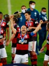 Soccer player Diego of Flamengo celebrates with the trophy after winning the Rio de Janeiro state championship at the Maracana stadium, Rio de Janeiro, Brazil, Wednesday, July 15, 2020. (AP Photo/Leo Correa)