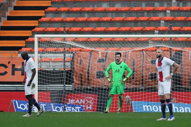 PSG's goalkeeper Sergio Rico, center, reacts after being defeated by FC Lorient during the French League One soccer match between FC Lorient and Paris Saint-Germain at the Moustoir stadium in Lorient, western France, Sunday, Jan. 31, 2021. (AP Photo/David Vincent)