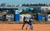 Young boys play soccer on a dusty field at Ramaphosa informal settlement, east of Johannesburg, South Africa, Tuesday, April 28, 2020. South Africa will begin a phased easing of its strict lockdown measures on May 1, although confirmed cases of coronavirus continue to increase. (AP Photo/Themba Hadebe)