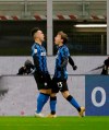 Inter Milan's Lautaro Martinez, left, celebrates his side's first goal with Nicolo Barella during the Italian Cup semi-final first leg soccer match between Inter Milan and Juventus at the San Siro stadium, in Milan, Italy, Tuesday, Feb. 2, 2021. (AP Photo/Luca Bruno)