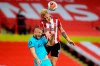 Tottenham's Eric Dier, left, and Sheffield United's Oliver McBurnie jump for the ball during the English Premier League soccer match between Sheffield United and Tottenham Hotspur at Bramall Lane in Sheffield, England, Thursday, July 2, 2020. (Michael Regan/Pool via AP)