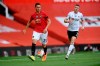 Manchester United's Nemanja Matic, left, passes the ball during the English Premier League soccer match between Manchester United and Sheffield United at Old Trafford in Manchester, England, Wednesday, June 24, 2020. (Michael Regan/Pool via AP)