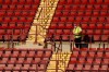 A stadium staffer stands in the empty stands before the English Premier League soccer match between Aston Villa and Sheffield United at the Villa Park stadium in Birmingham, Monday, Sept. 21, 2020. (Julian Finney/Pool via AP)