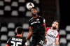 Leverkusen's Timothy Fosu-Mensah, left, jumps for a header with Essen's Simon Engelmann during the German Soccer Cup 3rd round match between RW Essen and Bayer Leverkusen in Essen, Germany, Tuesday, Feb. 2, 2021. (AP Photo/Martin Meissner, Pool)