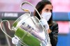 A member of the UEFA staff carries the Champions League trophy before the semifinal soccer match between RB Leipzig and Paris Saint-Germain at the Luz stadium in Lisbon, Portugal, Tuesday, Aug. 18, 2020. (David Ramos/Pool Photo via AP)