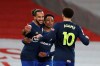 Southampton's Theo Walcott, left, celebrates after scoring his side's first goal during an English Premier League soccer match between Arsenal and Southampton at the Emirates stadium in London, England, Wednesday, Dec. 16, 2020. (Peter Cziborra/Pool via AP)