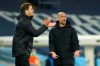 Manchester City's head coach Pep Guardiola, right, gestures during the Champions League, first leg, quarterfinal soccer match between Manchester City and Borussia Dortmund at the Etihad stadium in Manchester, Tuesday, April 6, 2021. (AP Photo/Dave Thompson)