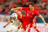 Bayern's Robert Lewandowski, right, controls the ball next to Sevilla's Sergio Escudero during the UEFA Super Cup soccer match between Bayern Munich and Sevilla at the Puskas Arena in Budapest, Hungary, Thursday, Sept. 24, 2020. (AP Photo/Laszlo Balogh, Pool)