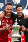 Arsenal's head coach Mikel Arteta and Arsenal's Pierre-Emerick Aubameyang pose with the trophy after the FA Cup final soccer match between Arsenal and Chelsea at Wembley stadium in London, England, Saturday, Aug.1, 2020. (Catherine Ivill/Pool via AP)