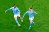 Manchester City's Phil Foden celebrates after scoring his side's second goal during the Champions League quarterfinal second leg soccer match between Borussia Dortmund and Manchester City at the Signal Iduna Park stadium in Dortmund, Germany, Wednesday, April 14, 2021. (Federico Gambarini/Pool via AP)
