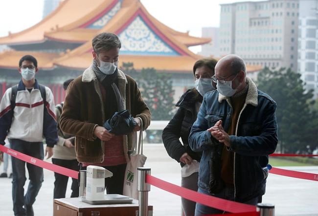 People wear face masks to protect against the spread of the new coronavirus as they visit the Chiang Kai-shek Memorial Hall in Taipei, Taiwan, Thursday, Feb. 27, 2020. As the worst-hit areas of Asia continued to struggle with a viral epidemic, with hundreds more cases reported Thursday in South Korea and China, worries about infection and containment spread across the globe. (AP Photo/Chiang Ying-ying)