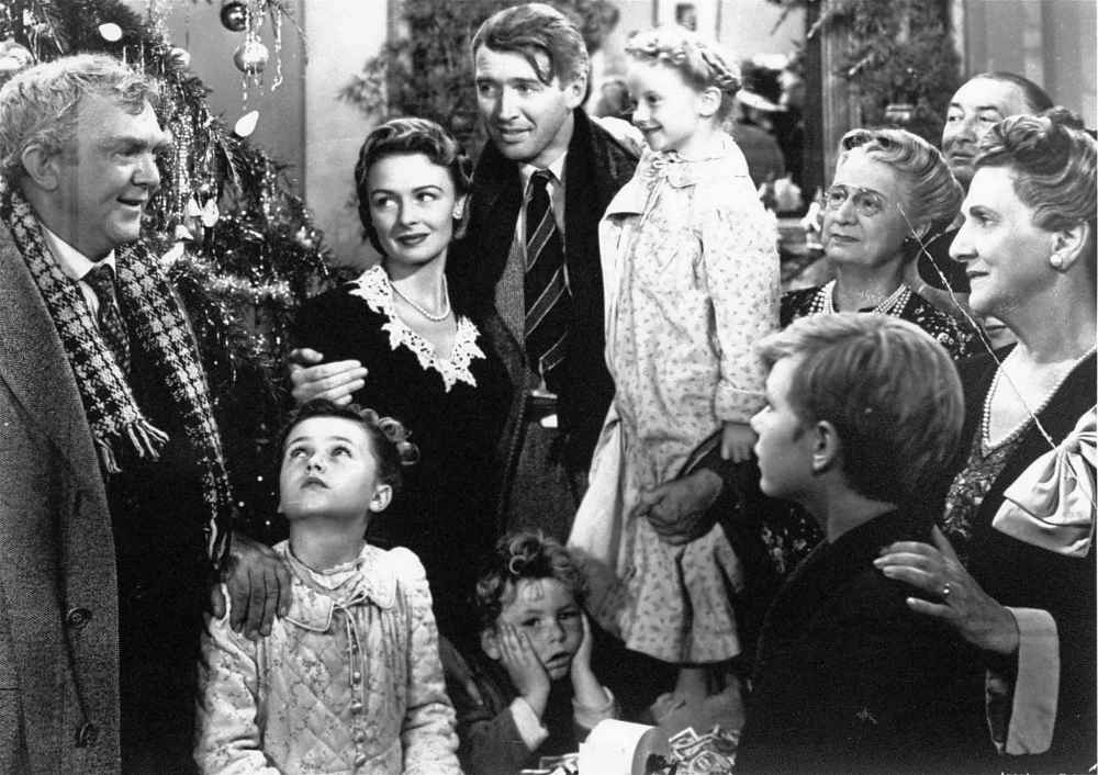 James Stewart, center, as George Bailey is reunited with his wife, played by Donna Reed, left center, and their children during the final scene of Frank Capra's 1946 movie, 