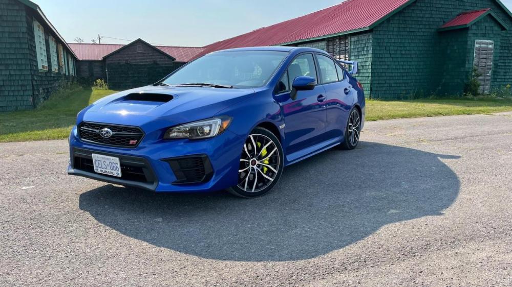 From the front, the STI’s appearance is dominated by a large hexagonal grille and hood scoop.