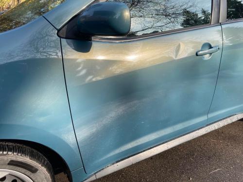 - Mark Toljagic
The author’s daughter’s Pontiac Vibe with two dents shown: shallow crease in front fender popped out easily, while the deep dent in the driver’s door remained stubborn and required the help of a pro.