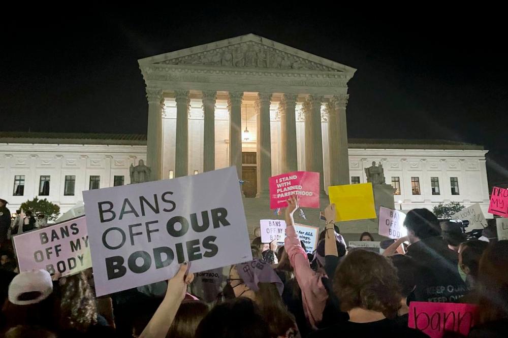 Anna Johnson - The Associated Press
A crowd of people gather outside the Supreme Court, Monday night in Washington. A draft opinion circulated among Supreme Court justices suggests that earlier this year a majority of them had thrown support behind overturning the 1973 case Roe v. Wade that legalized abortion nationwide, according to a report published Monday night in Politico.