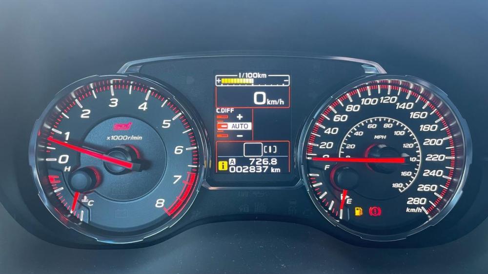 The STI’s instrument cluster features an array of classic white-faced analogue gauges.