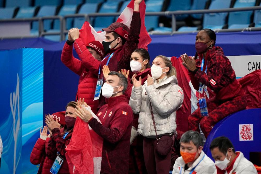 David J. Phillip - AP
The team cheers for Piper Gilles and Paul Poirier, of Canada, during the ice dance team program in the figure skating competition at the 2022 Winter Olympics, Friday, Feb. 4, 2022, in Beijing.