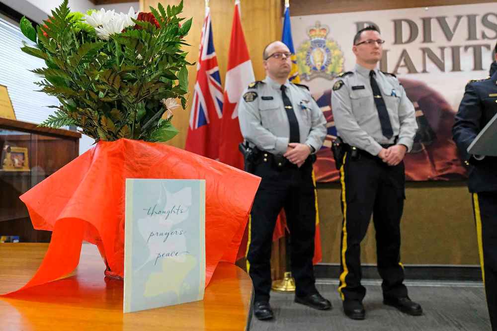 Flowers and a card sit on table at D Division Headquarters Saturday afternoon as RCMP Assistant Commissioner Jane MacLatchy provides details about the death of Const. Allan Poapst. (Daniel Crump / Winnipeg Free Press)