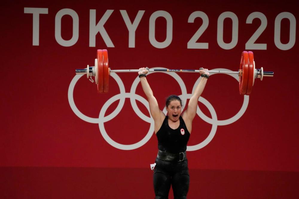Luca Bruno - The Associated Press
Maude G. Charron of Canada celebrates after her lift in the women's 64-kilogram weightlifting event.