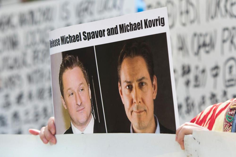 JASON REDMOND - AFP via Getty Images
A demonstrator holds a photo of detained Canadians Michael Spavor, left, and Michael Kovrig outside a court appearance for Huawei Chief Financial Officer, Meng Wanzhou at the British Columbia Supreme Court in Vancouver in 2019.