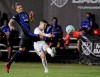 Montreal Impact forward Maximiliano Urruti, left, tries to block a shot by D.C. United defender Joseph Mora during the second half of an MLS soccer match, early Wednesday, July 22, 2020, in Kissimmee, Fla. (AP Photo/John Raoux)