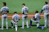 Toronto Blue Jays players, from left, Lourdes Gurriel Jr. (13), Santiago Espinal (5), Cavan Biggio (8), Anthony Alford (30), and Rowdy Tellez (44) during the playing of the U.S. National Anthem before a baseball game against the Tampa Bay Rays Friday, July 24, 2020, in St. Petersburg, Fla. (AP Photo/Chris O'Meara)