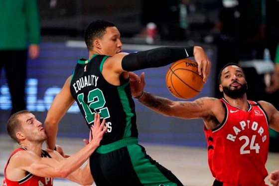 Boston Celtics' Grant Williams (12) battles for a rebound with Toronto Raptors' Matt Thomas, left, and Toronto Raptors' Norman Powell (24) during the second half of an NBA conference semifinal playoff basketball game Monday, Sept. 7, 2020, in Lake Buena Vista, Fla. (AP Photo/Mark J. Terrill)